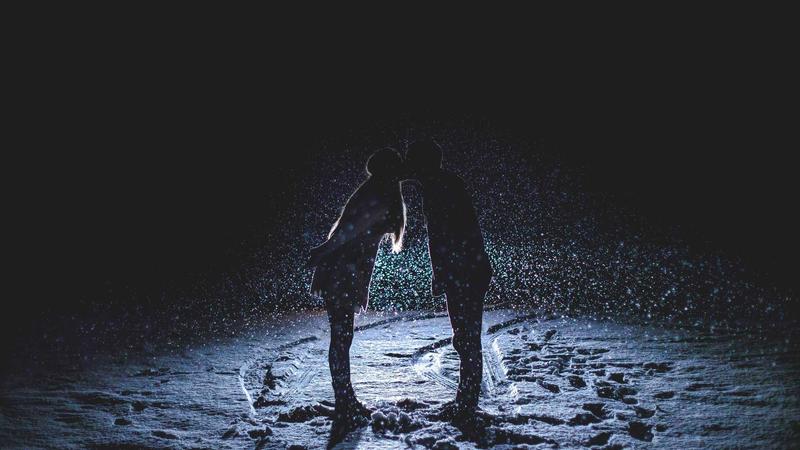 Red wine glass and grapes on wooden table